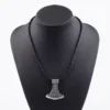 Viking axe pendant necklace in stainless steel with intricate Norse knotwork and rune detailing, shown with dimensional measurements (3.6cm x 4cm) and a weight of 17g against an atmospheric Norse warrior background.