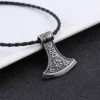 Viking axe pendant necklace in stainless steel with intricate Norse knotwork and rune detailing, shown with dimensional measurements (3.6cm x 4cm) and a weight of 17g against an atmospheric Norse warrior background.