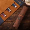 Dark brown faux leather roll-up pencil case with vintage treasure map design and embossed buckle